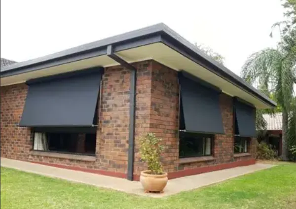 Dark fabric awnings on a brick home