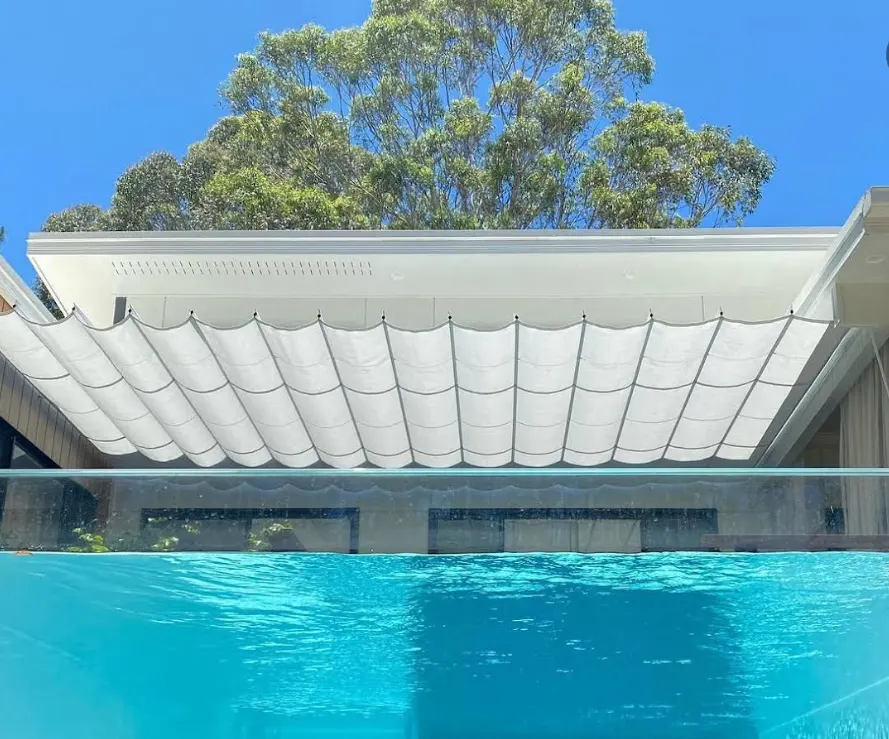 Retractable roof awning above a pool