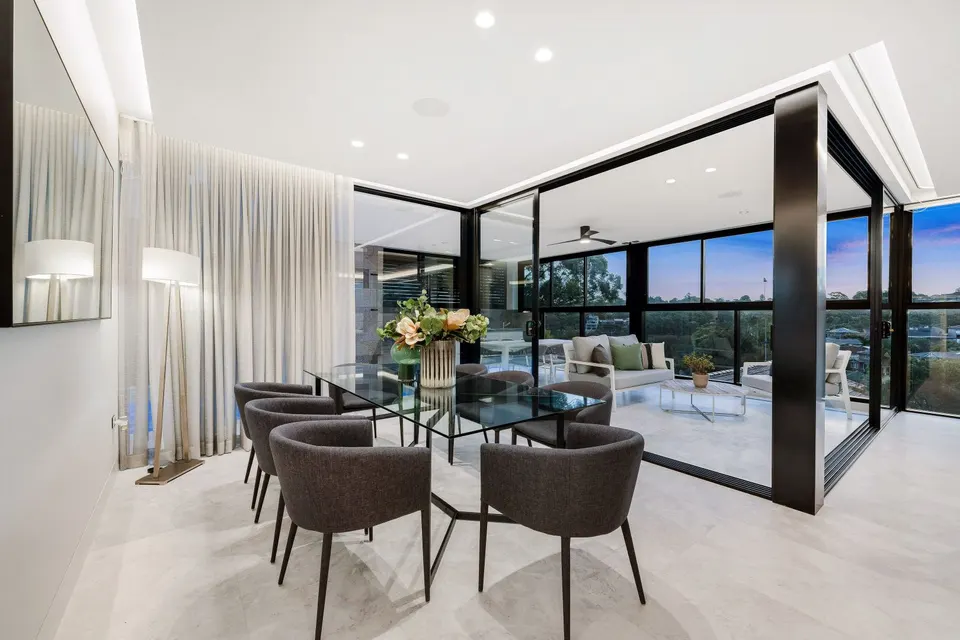 Sheer curtains around a glass-walled dining room, Hurstville Grove