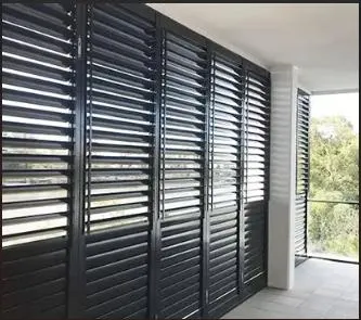 Black external louvre shutters on a balcony