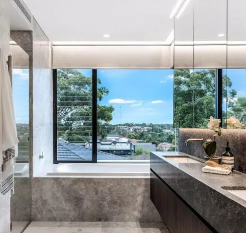 Roller blind in a bathroom with a district view