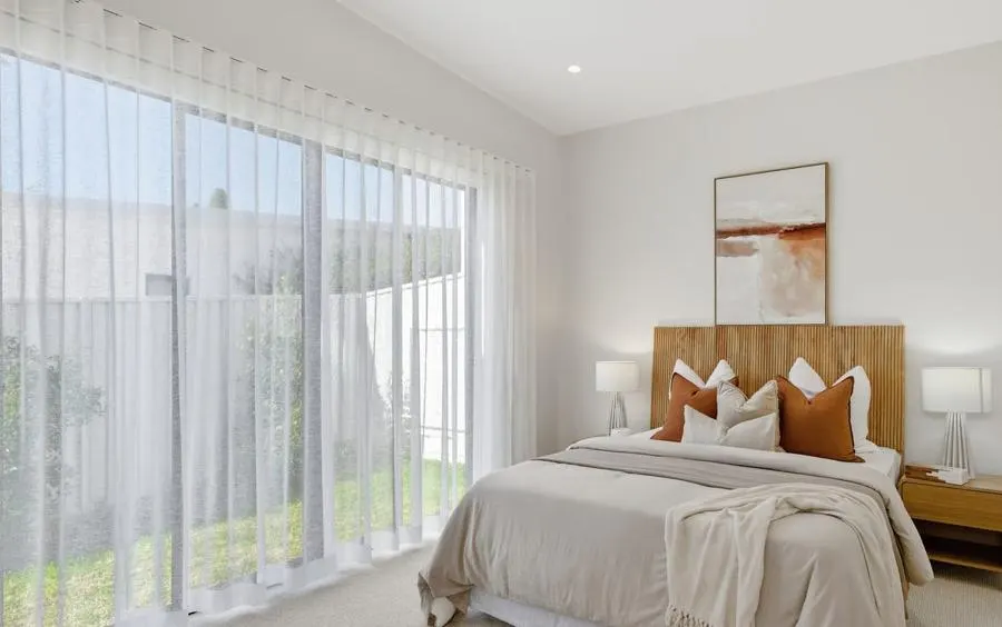 Floor-to-ceiling sheer curtains in a bedroom