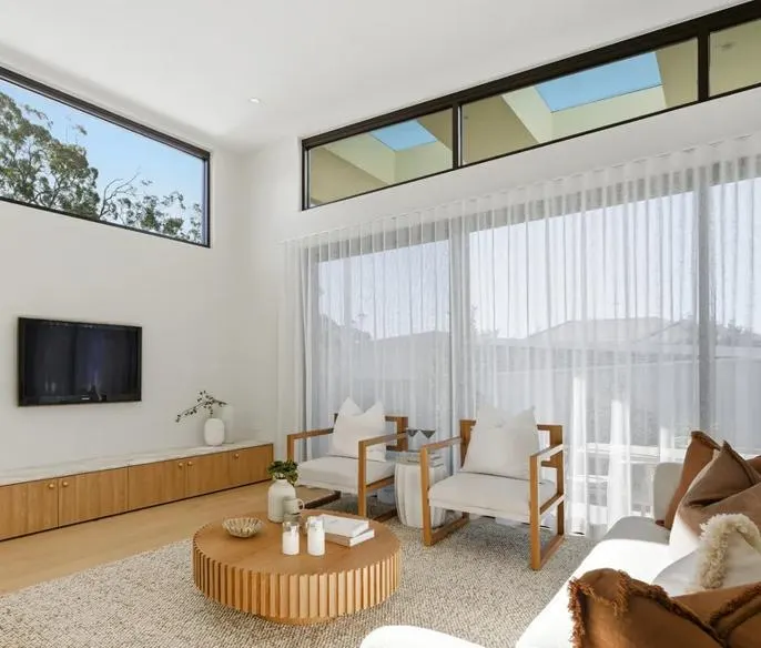 Sheer curtains in a bright living room under clerestory windows