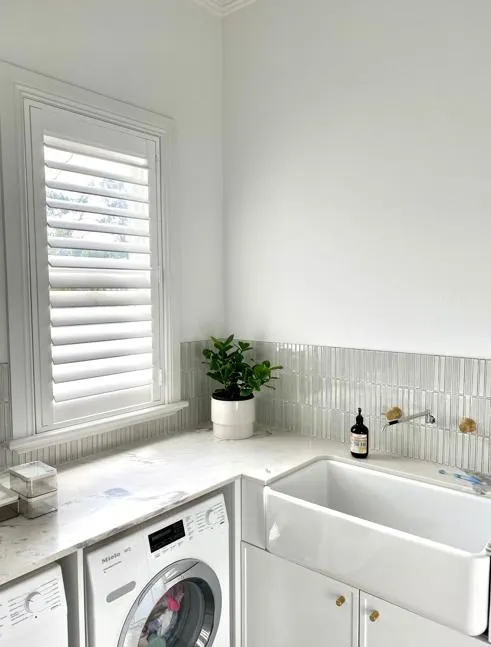 White plantation shutters in a laundry