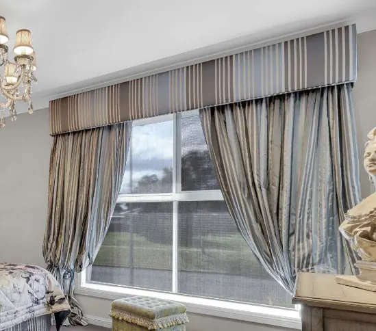 Upholstered striped pelmet over full-length curtains