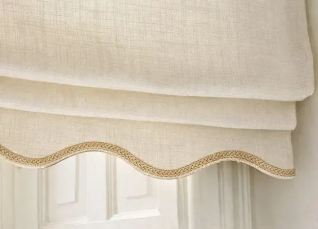 Detail of a scalloped Roman blind valance with braid trim