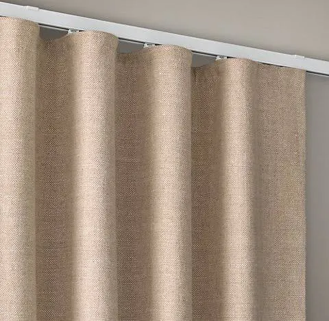 Linen wave-fold curtains on a ceiling track